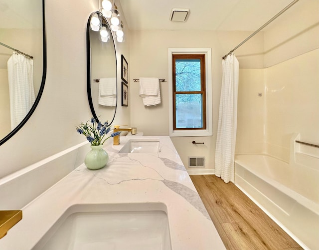 809 Wagon Wheel Trl, Mendota Heights, MN 55120 - bathroom featuring vanity, shower / bath combination with curtain, baseboards, wood finished floors, and visible vents