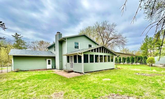 809 Wagon Wheel Trl, Mendota Heights, MN 55120 - back of property featuring a sunroom, fence, a yard, and a chimney