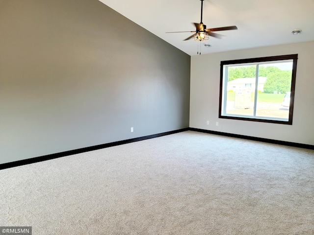 unfurnished room featuring baseboards, a ceiling fan, lofted ceiling, and light carpet