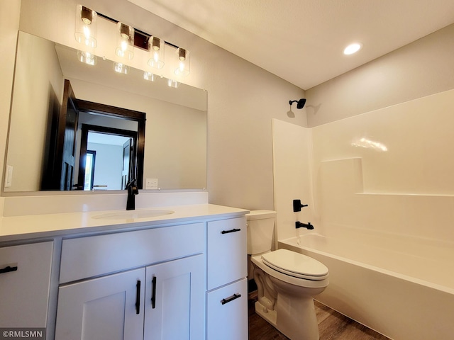 full bathroom featuring vanity, shower / tub combination, wood finished floors, and toilet