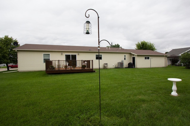 932 Spruce Ave S, Thief River Falls, MN 56701 - rear view of house featuring a lawn, central AC, and a wooden deck