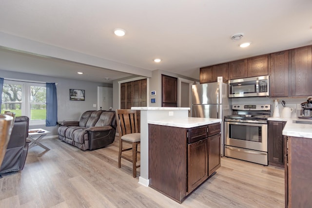 43 Blue Stem Rd, Shetek Twp, MN 56175 - kitchen featuring appliances with stainless steel finishes, open floor plan, a breakfast bar area, light countertops, and a center island