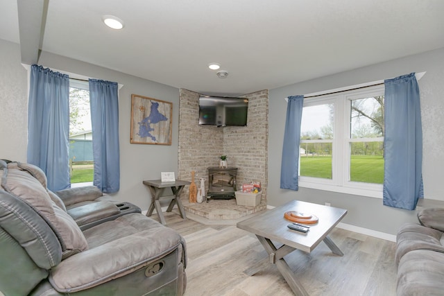 43 Blue Stem Rd, Shetek Twp, MN 56175 - living area with a wood stove, light wood-type flooring, recessed lighting, and baseboards