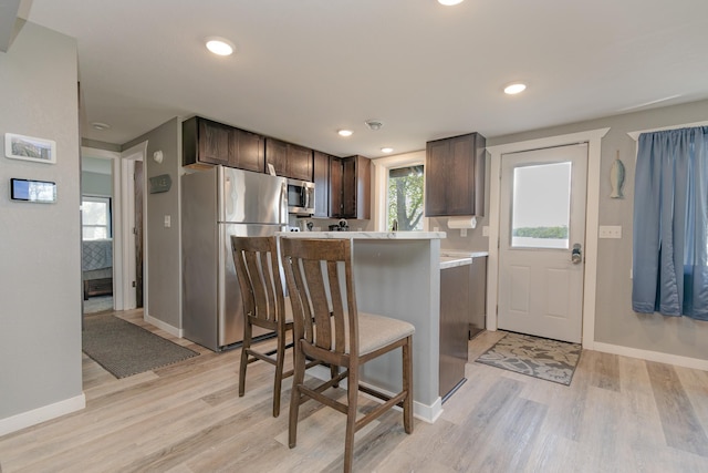 43 Blue Stem Rd, Shetek Twp, MN 56175 - kitchen featuring appliances with stainless steel finishes, dark brown cabinets, light wood finished floors, light countertops, and baseboards