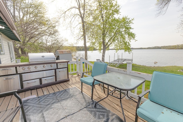 43 Blue Stem Rd, Shetek Twp, MN 56175 - wooden terrace with a water view, a storage unit, an outbuilding, and grilling area