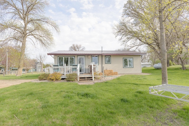 43 Blue Stem Rd, Shetek Twp, MN 56175 - back of house with a deck, a lawn, and metal roof