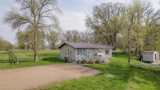 43 Blue Stem Rd, Shetek Twp, MN 56175 - view of front of property featuring a storage unit, an outdoor structure, a front lawn, and metal roof