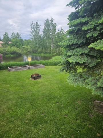 view of yard with an outdoor fire pit