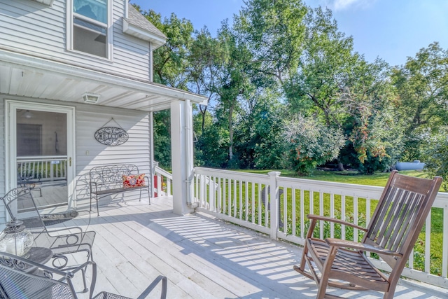 deck featuring a porch and a yard