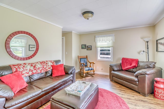 living area featuring baseboards, ornamental molding, and wood finished floors