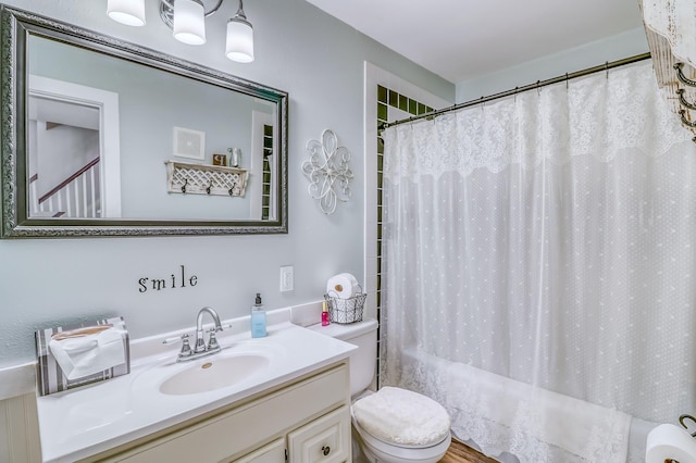 bathroom with toilet, shower / bathtub combination with curtain, and vanity