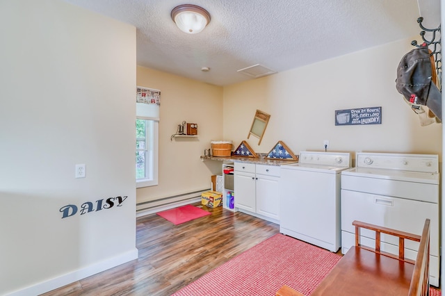 clothes washing area featuring a textured ceiling, independent washer and dryer, light wood-type flooring, cabinet space, and a baseboard radiator