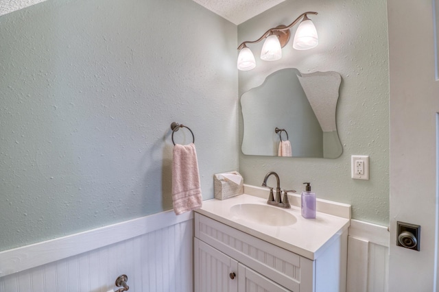 bathroom with vanity and wainscoting