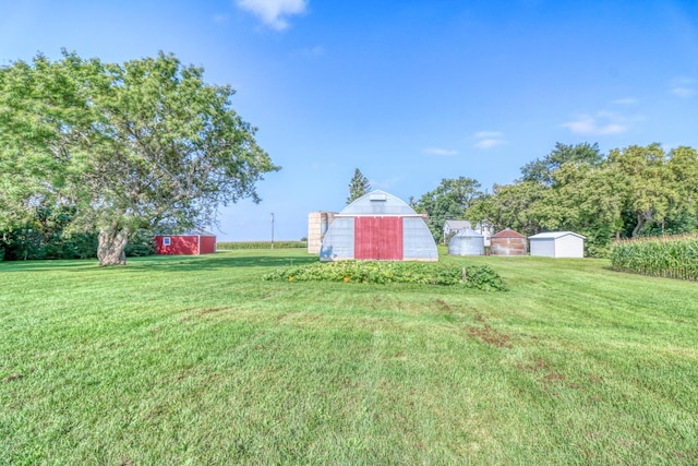 view of yard with a storage unit, an outdoor structure, and a barn