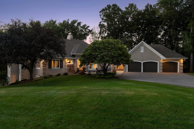 2454 Crowne Hill Rd, Minnetonka, MN 55305 - view of front of home featuring an attached garage, stucco siding, a chimney, concrete driveway, and a yard