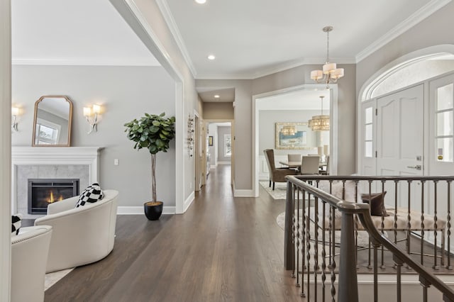 2454 Crowne Hill Rd, Minnetonka, MN 55305 - entrance foyer featuring baseboards, a notable chandelier, dark wood-style floors, and a fireplace