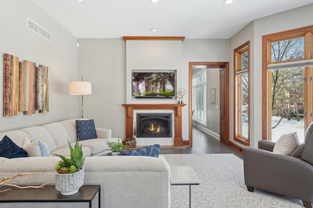 2454 Crowne Hill Rd, Minnetonka, MN 55305 - living room featuring a glass covered fireplace, dark wood-type flooring, recessed lighting, and visible vents