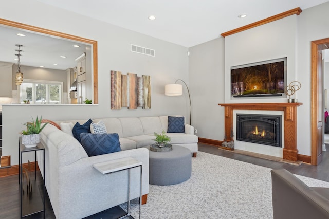 2454 Crowne Hill Rd, Minnetonka, MN 55305 - living room featuring a fireplace with flush hearth, recessed lighting, wood finished floors, and visible vents