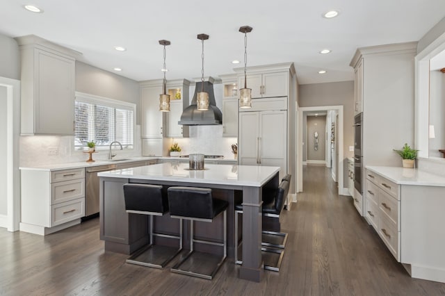2454 Crowne Hill Rd, Minnetonka, MN 55305 - kitchen featuring a kitchen island, appliances with stainless steel finishes, wall chimney exhaust hood, and light countertops