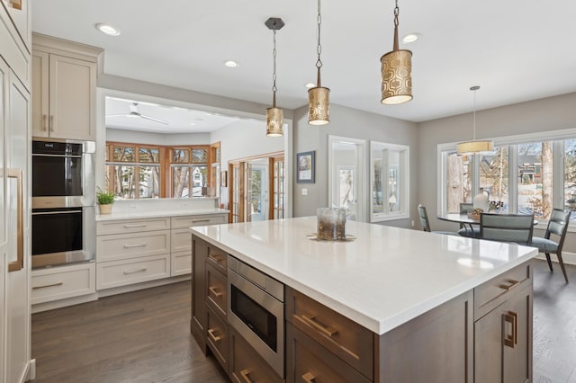 2454 Crowne Hill Rd, Minnetonka, MN 55305 - kitchen featuring pendant lighting, dark wood-style floors, recessed lighting, light countertops, and stainless steel appliances