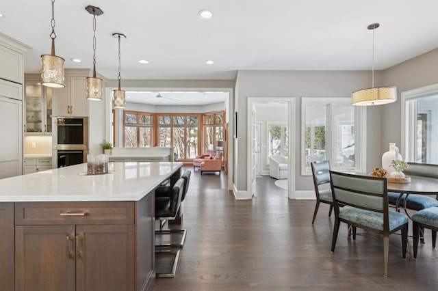 2454 Crowne Hill Rd, Minnetonka, MN 55305 - kitchen with stainless steel double oven, light countertops, recessed lighting, baseboards, and dark wood-type flooring