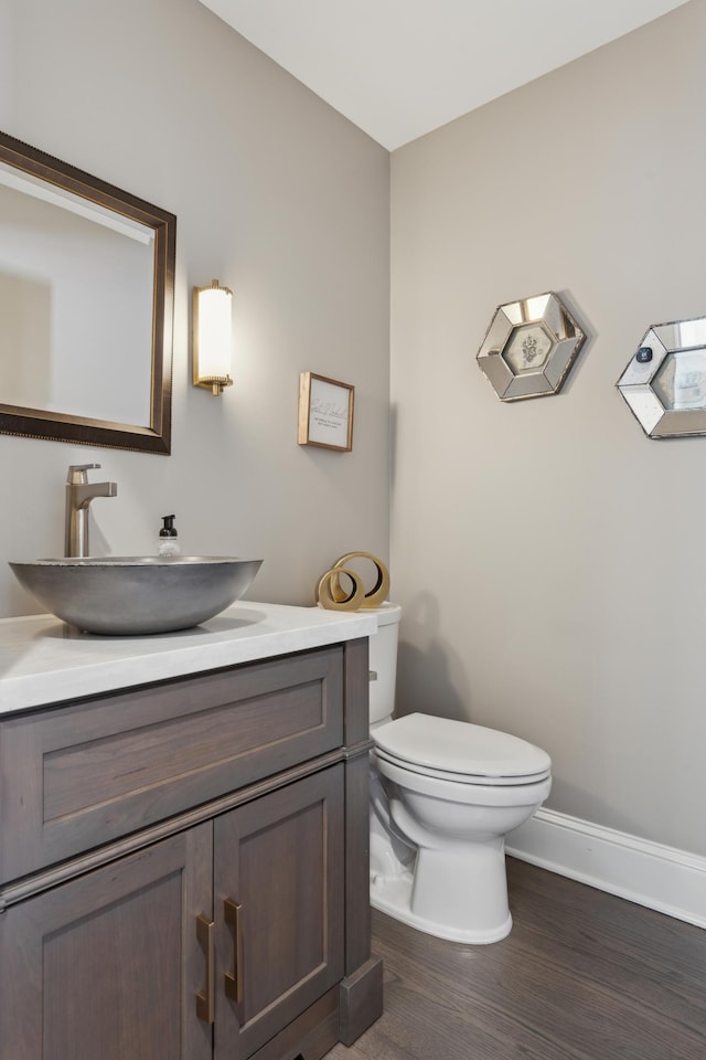 2454 Crowne Hill Rd, Minnetonka, MN 55305 - bathroom featuring vanity, baseboards, toilet, and wood finished floors