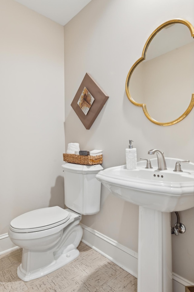 2454 Crowne Hill Rd, Minnetonka, MN 55305 - bathroom with a sink, baseboards, and toilet