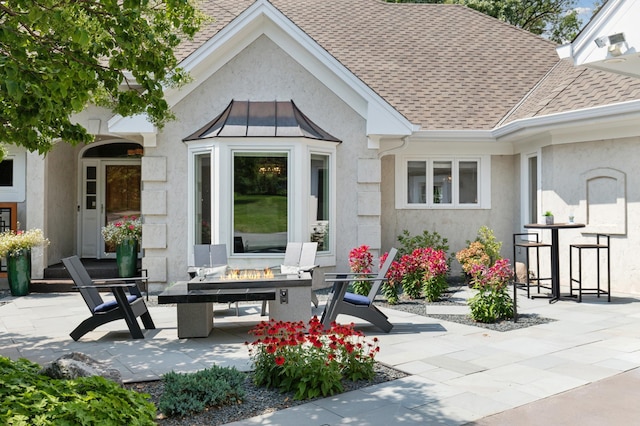 2454 Crowne Hill Rd, Minnetonka, MN 55305 - exterior space featuring a patio, a shingled roof, stucco siding, and a standing seam roof