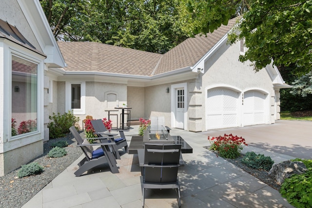 2454 Crowne Hill Rd, Minnetonka, MN 55305 - view of patio featuring an attached garage, a fire pit, and concrete driveway