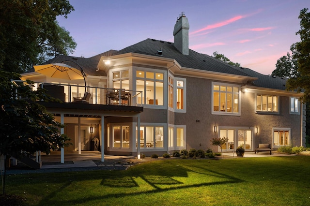 2454 Crowne Hill Rd, Minnetonka, MN 55305 - back of property featuring a chimney, a lawn, a balcony, a patio, and stucco siding