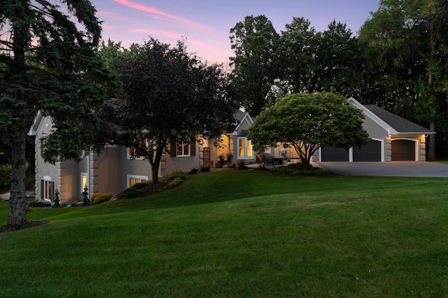 2454 Crowne Hill Rd, Minnetonka, MN 55305 - view of front of home featuring a lawn, an attached garage, concrete driveway, and stucco siding