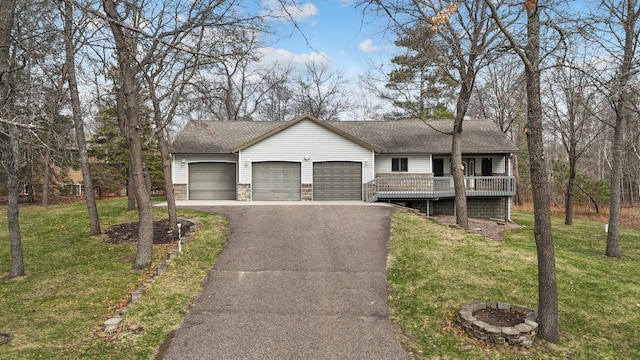 ranch-style house featuring an attached garage, driveway, a shingled roof, and a front lawn