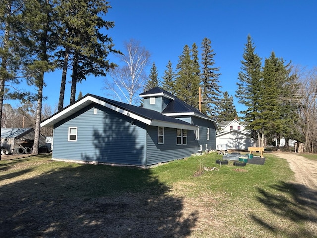 view of property exterior featuring a lawn