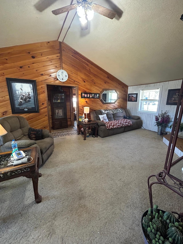 bedroom featuring wooden walls, vaulted ceiling, carpet flooring, and a textured ceiling