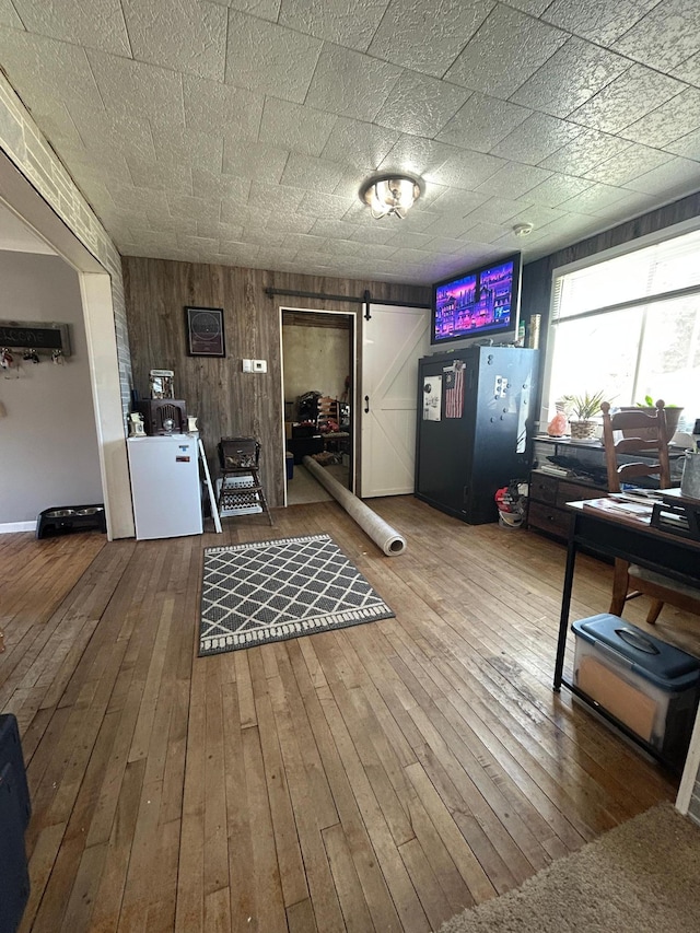interior space featuring wood-type flooring and wooden walls