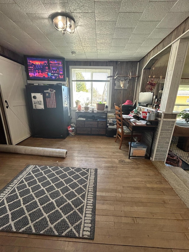interior space with wooden walls and hardwood / wood-style flooring