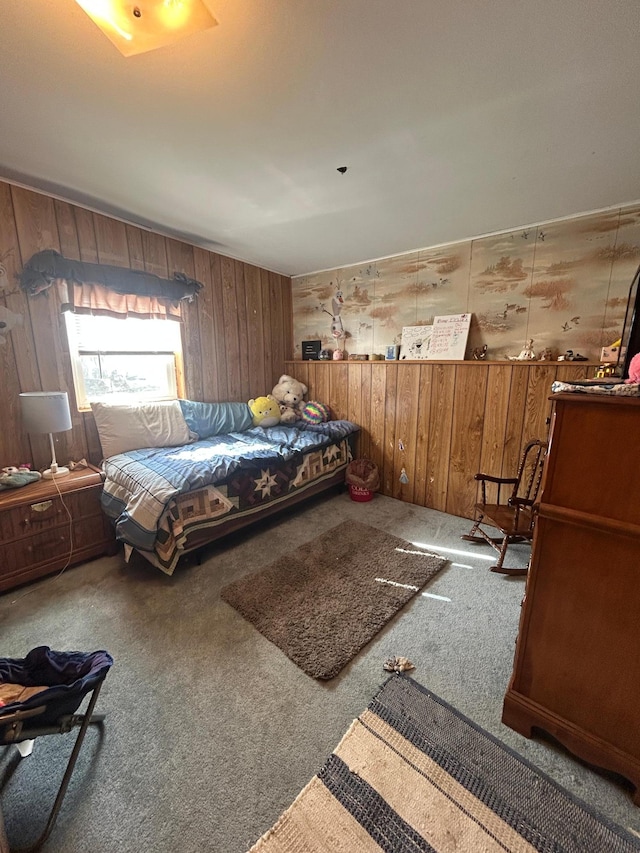 bedroom with carpet floors and wood walls