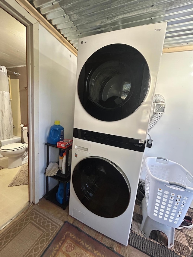 laundry room with laundry area and stacked washer and clothes dryer
