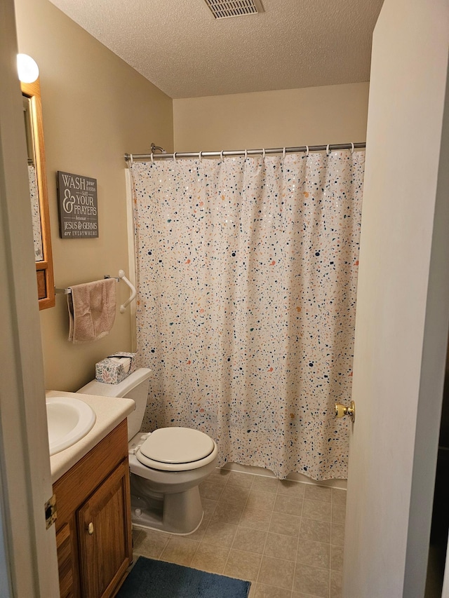 bathroom with a textured ceiling, tile patterned flooring, vanity, toilet, and a shower with shower curtain
