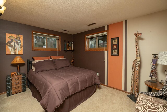 bedroom featuring carpet, a textured ceiling, and baseboards