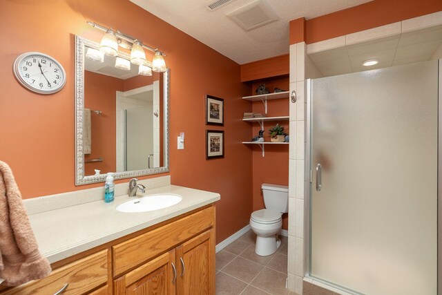 bathroom featuring a stall shower, toilet, and tile patterned flooring