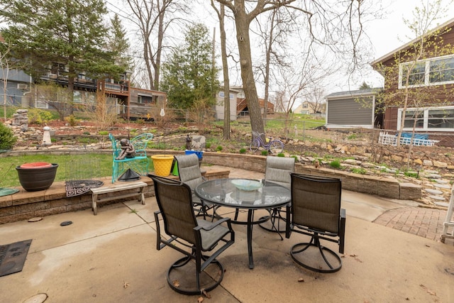 view of patio with outdoor dining space and fence