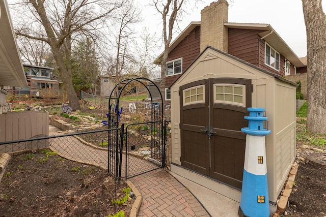 view of shed with a gate and fence