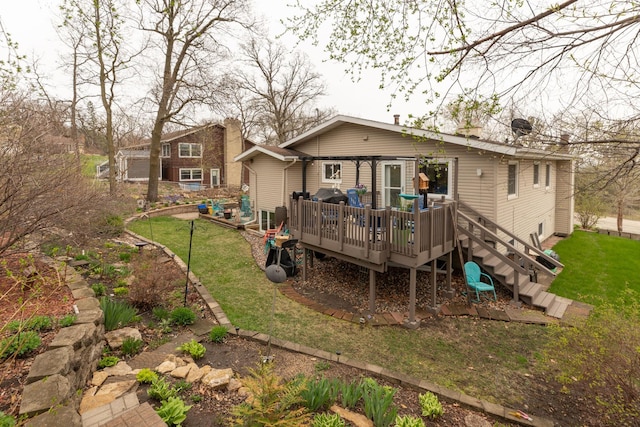 rear view of property with a deck and a yard