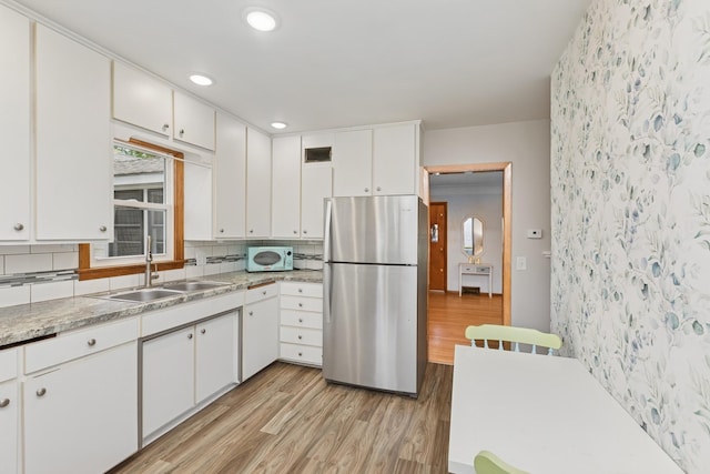 3215 146th St W, Rosemount, MN 55068 - kitchen with freestanding refrigerator, a sink, white microwave, light wood-style floors, and wallpapered walls