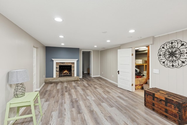 3215 146th St W, Rosemount, MN 55068 - unfurnished living room with light wood-style flooring, recessed lighting, a stone fireplace, and baseboards