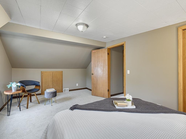 bedroom with carpet, vaulted ceiling, and baseboards