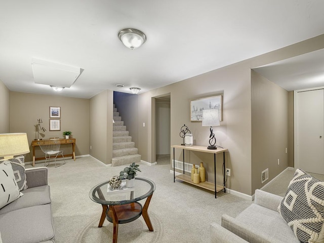 living area featuring stairway, baseboards, and light carpet