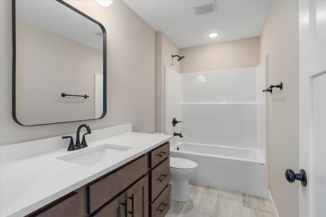 full bathroom featuring visible vents, bathing tub / shower combination, toilet, and vanity