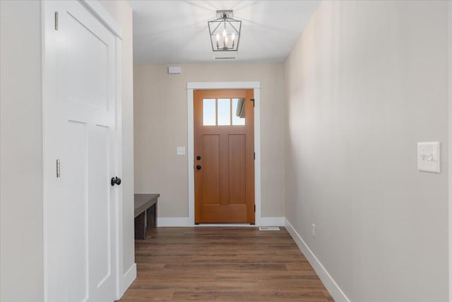 entryway featuring baseboards and wood finished floors